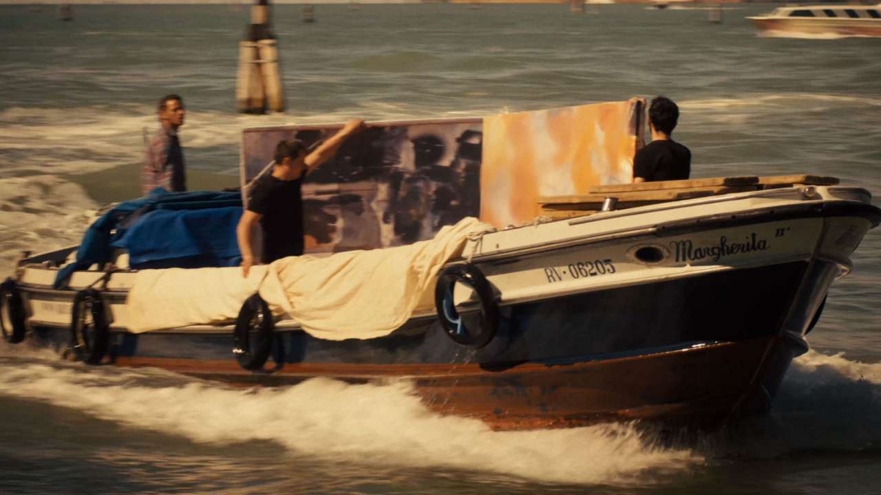 three people on a boat with a painting